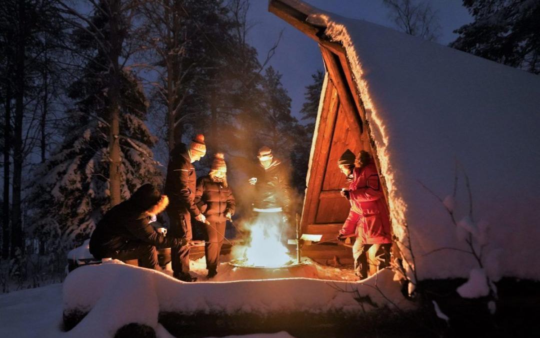 Northern lights around the open fire