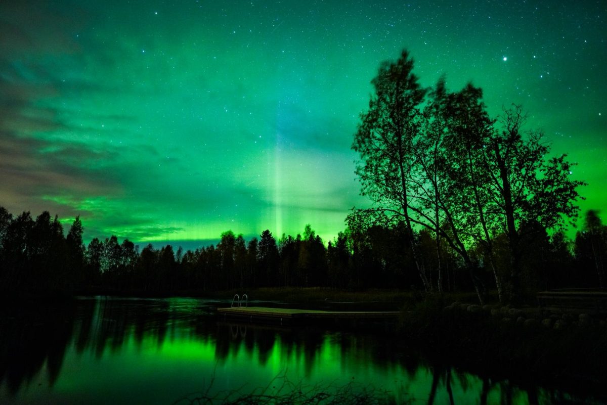 Aurora Dancing Over the Lakeside Sauna
