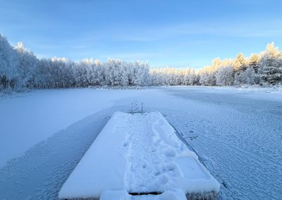 Sauna with swimming in frozen lake in Rovaniemi